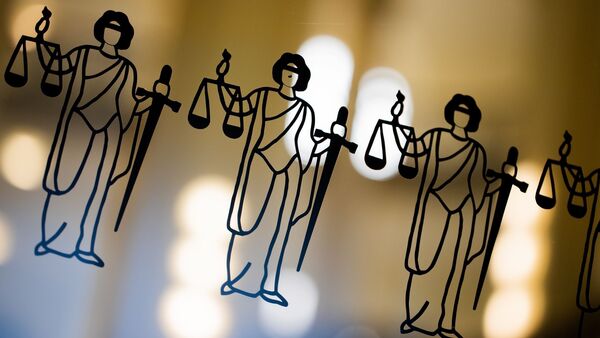 Die Justitia ist an einer Scheibe am Eingang zum Oberlandesgericht zu sehen., © Rolf Vennenbernd/dpa/Symbolbild