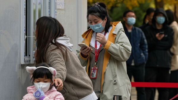 Anwohner an einer Coronavirus-Teststelle in Peking., © Andy Wong/AP/dpa